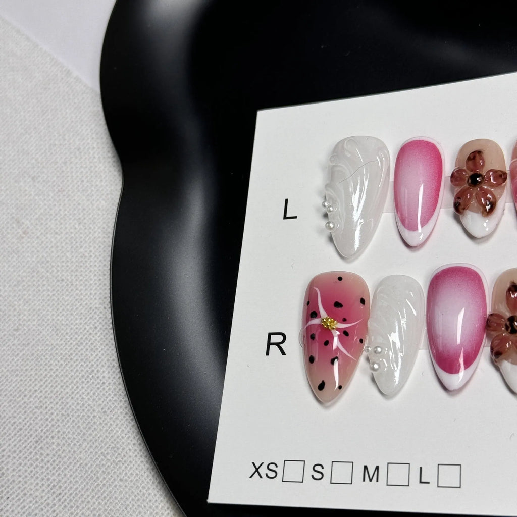 Close-up of hand-painted 3D nail patch with embossed candy pattern on an almond-shaped nail.