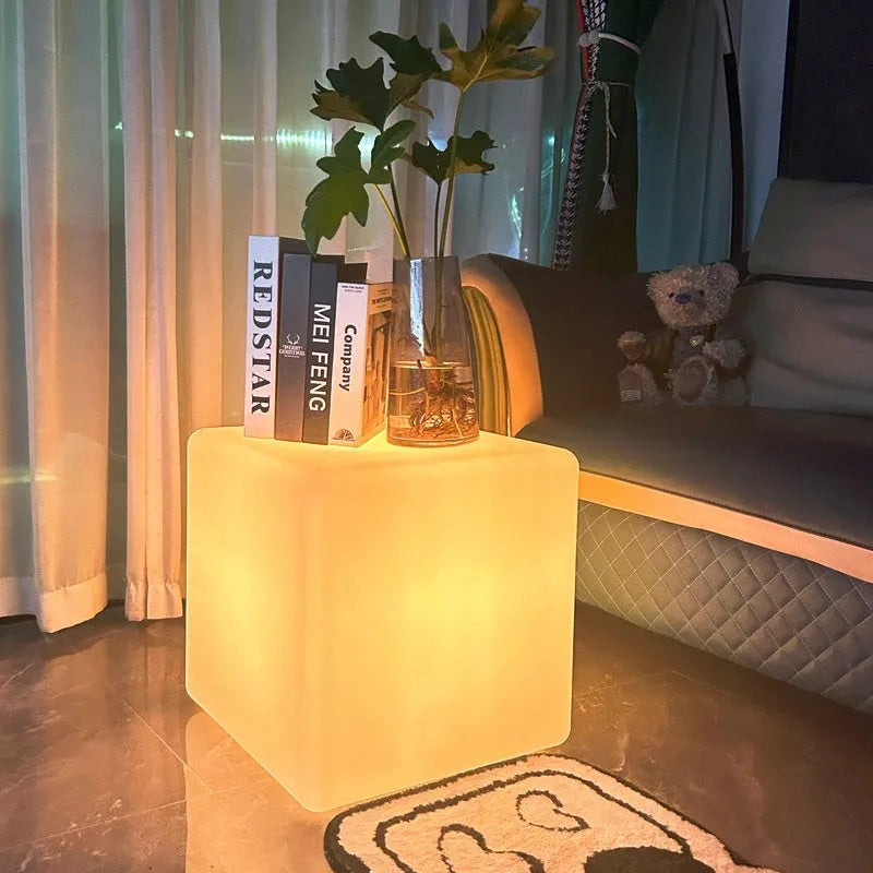 Modern white LED cube stool light outdoors, showing clean square design and soft illumination.