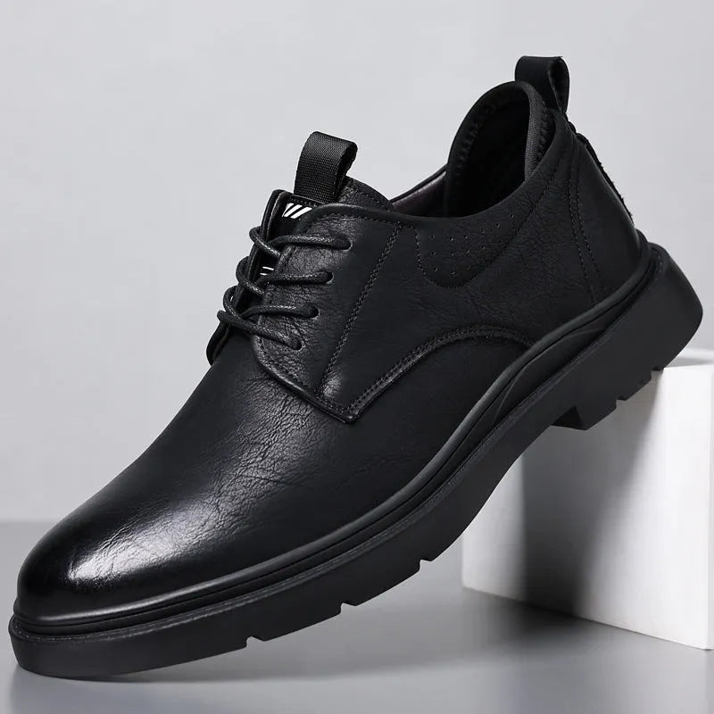 Men's black and brown leather casual sneakers with sewing line details on a two-layer cowhide upper.