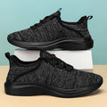 Women's low-top casual sneaker in mesh fabric with round toe and flat sole, shown in black.