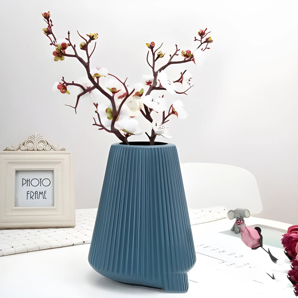 Colourful melamine plastic decorative flower vase on a tabletop.