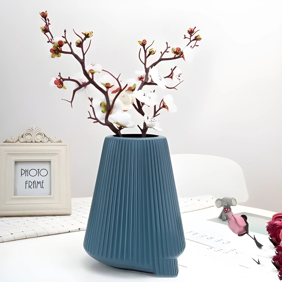 Colourful melamine plastic decorative flower vase on a tabletop.