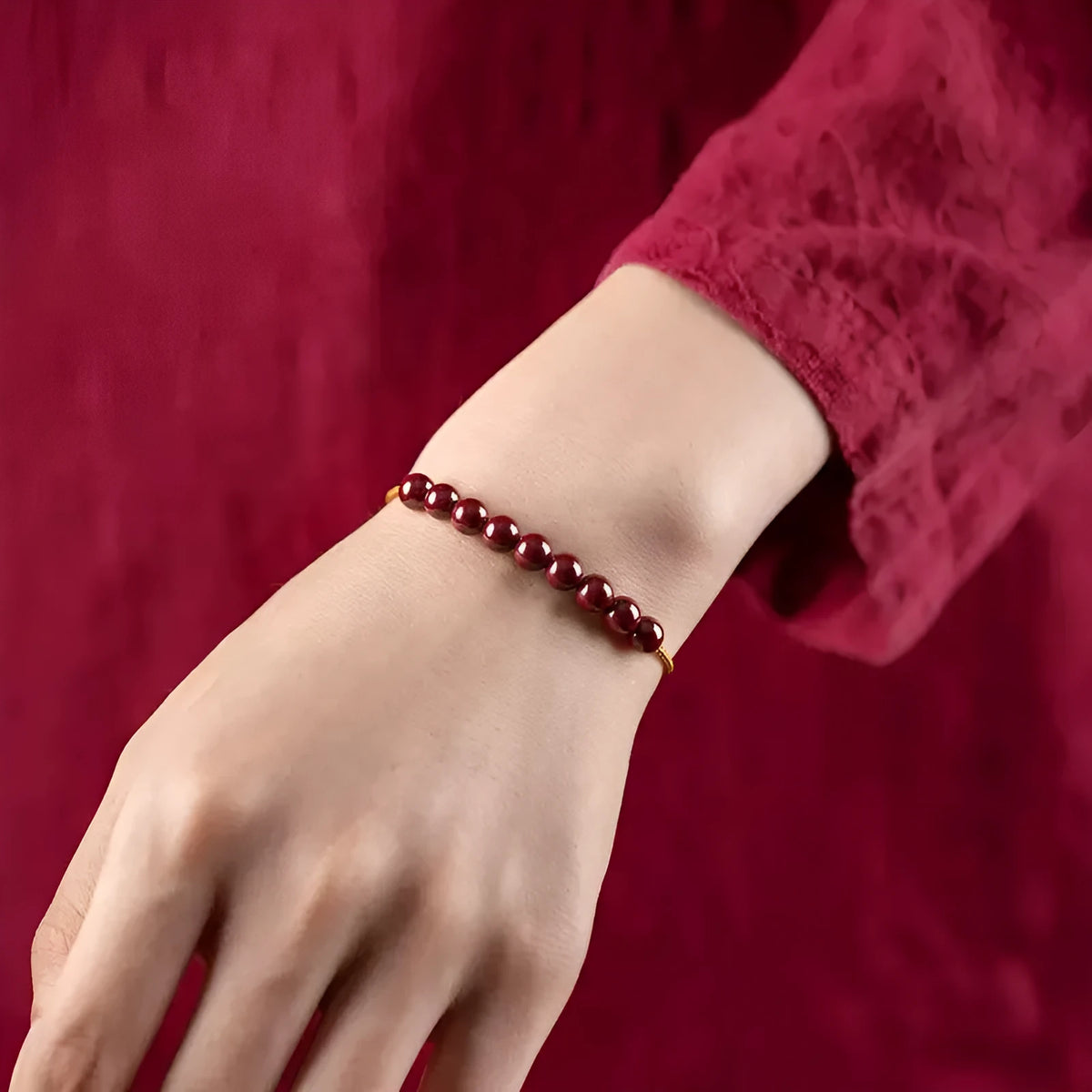 Close-up of a red cinnabar and beige Hetian jade geometric bracelet with a hand-woven adjustable strap.