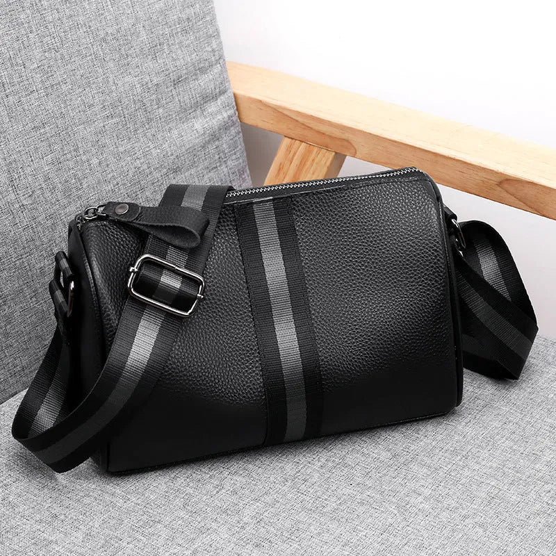 Black genuine leather crossbody bag with one-shoulder design showing 24x16x13cm dimensions