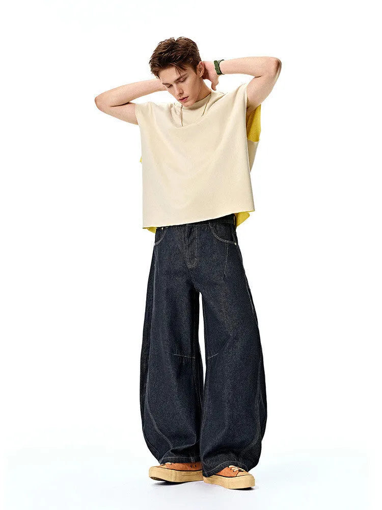 Men's original cow colour wide leg denim trousers on a mid-waist model.