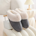 Brown plush women's slippers with a round toe, flat heel, and textured non-slip sole.