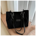 Corduroy one-shoulder tote handbag with three-dimensional pockets in black colour
