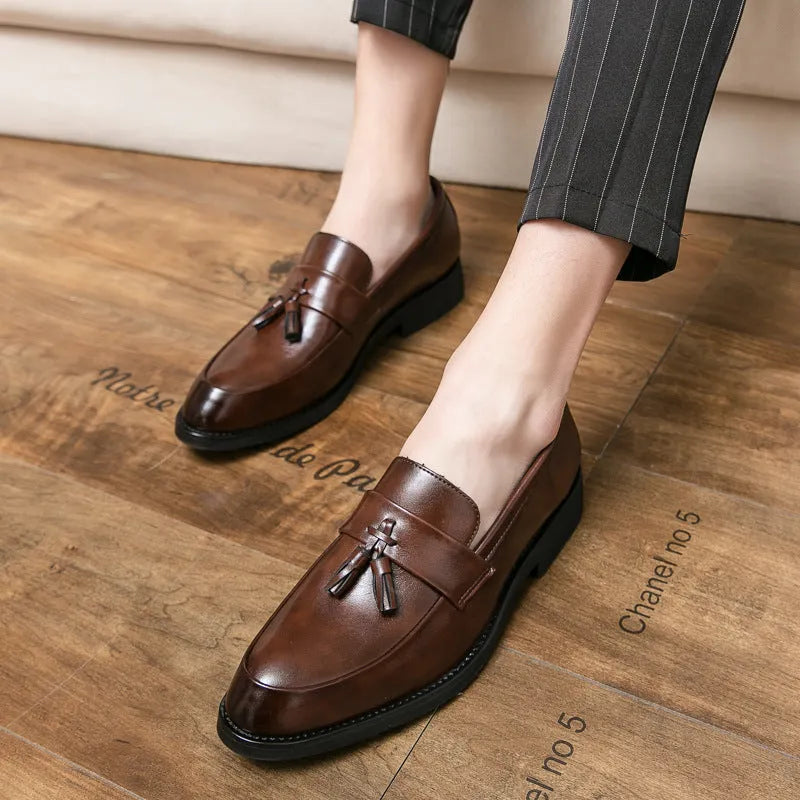 Men's black business casual slip-on shoes with tassel detail and rubber sole