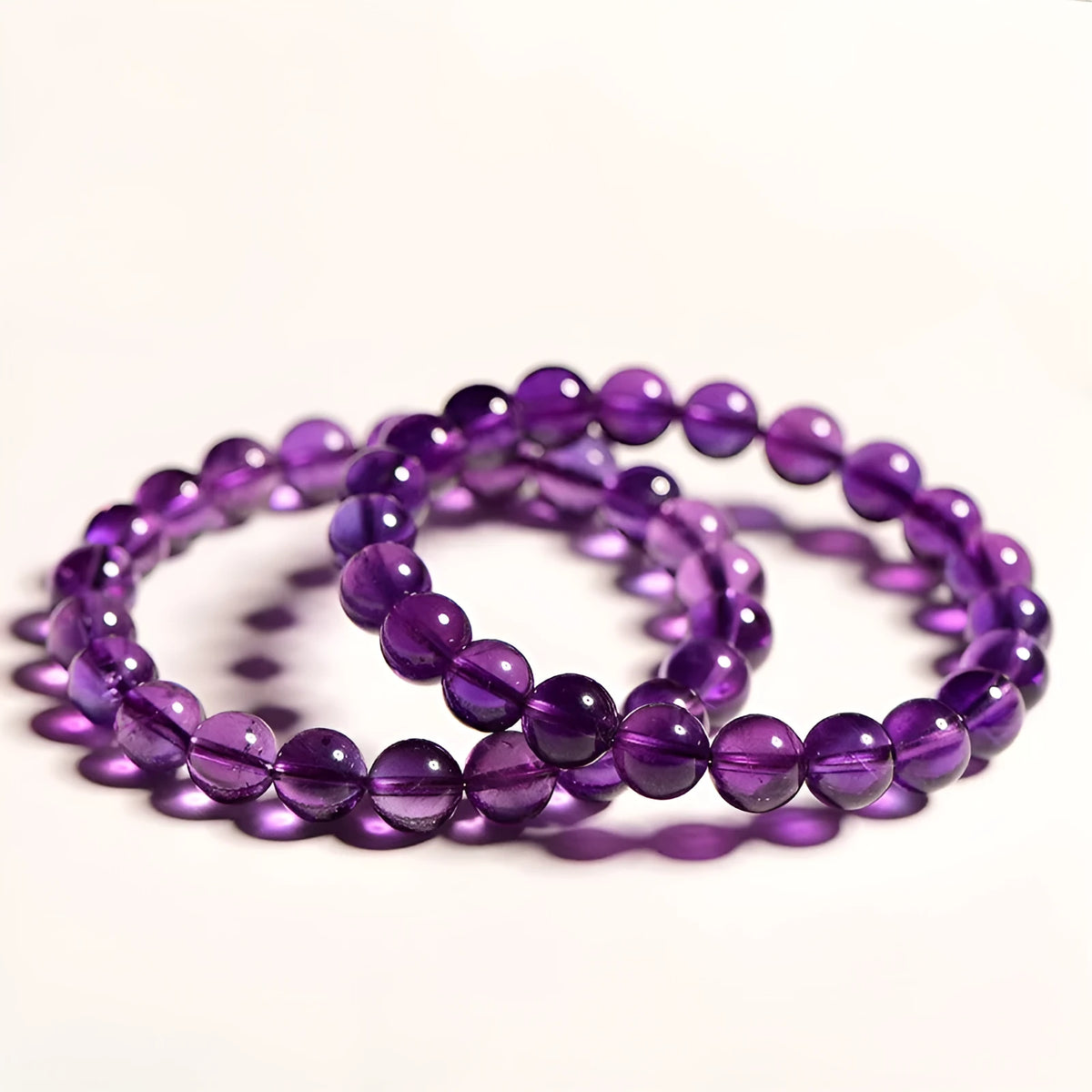 Natural amethyst scattered bead bracelet on wrist showing polished crystal and size options.