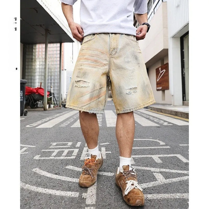 Light blue distressed denim shorts for men with ripped details and straight-leg fit.