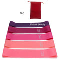 Five yoga tension straps in different colours with force markings for progressive resistance training