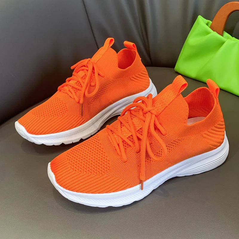 Women's creamy white mesh running shoes with flyknit upper and flat rubber sole