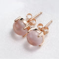 Rose gold drop shape stud earrings with crystal inlay detail on synthetic ross quartz