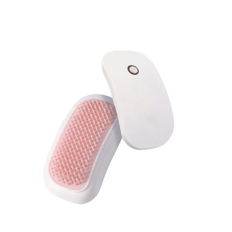 Pink handheld electric vibration brush for grooming and massaging cats and dogs.