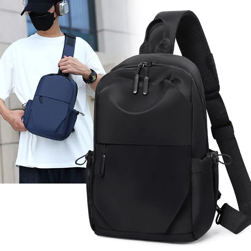Men's grey waterproof large chest bag with shoulder strap, showing front pocket and main compartment.