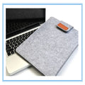Dark grey clamshell laptop bag made of woven plush material, shown open to reveal the internal computer compartment.
