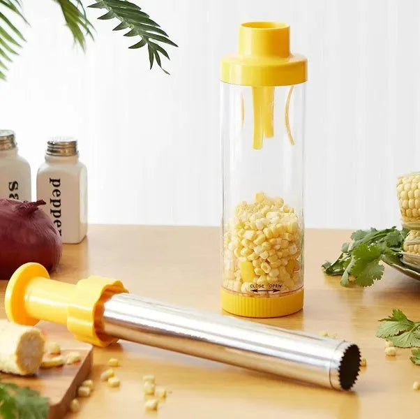 Yellow cylindrical corn stripper kitchen tool with stainless steel components on a kitchen worktop.