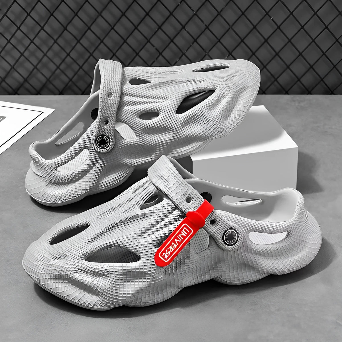 Korean style grey EVA closed-toe coconut slippers on a sandy beach background.