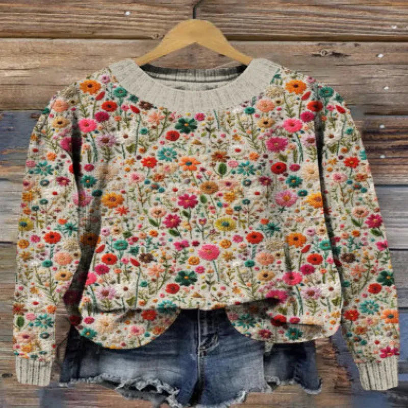 Women's grey round neck sweater with a small white digital flower print pattern.