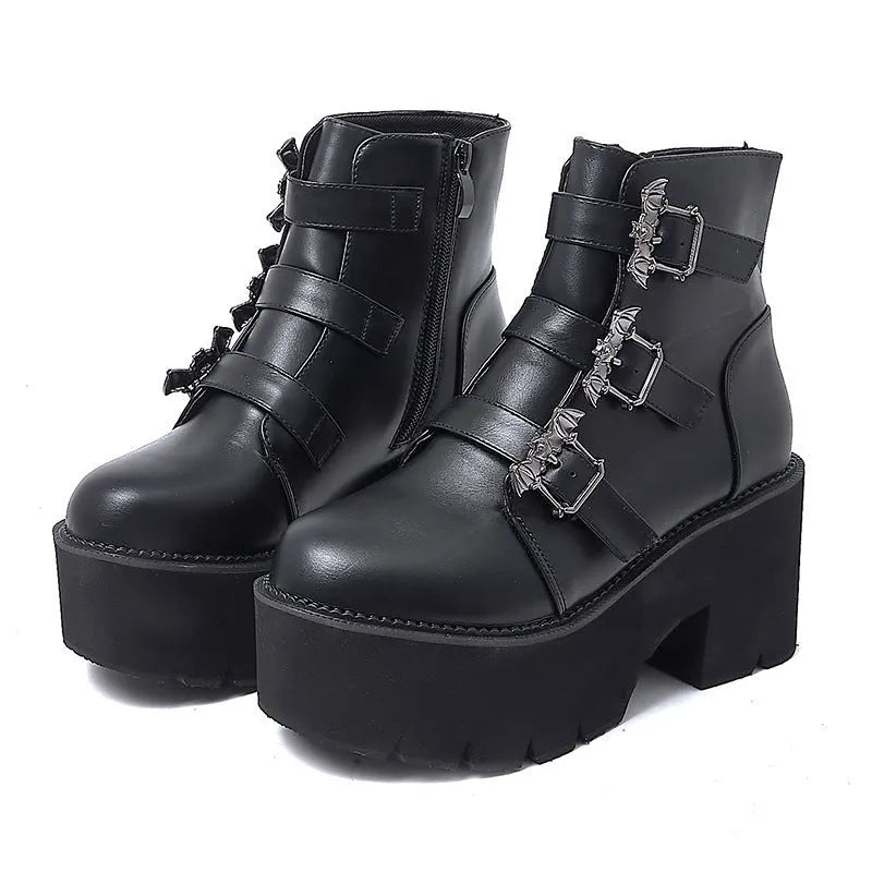 Black women's gothic punk Martin boots with a silver bat buckle and side zip.