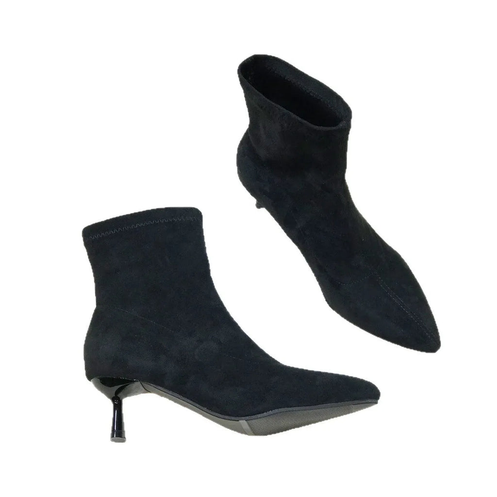 Women's black pointed toe ankle boots with a stiletto heel on a white background.