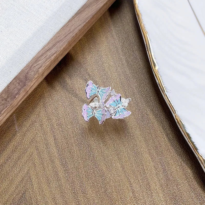 Adjustable copper insect ring with dripped oil finish in an irregular, artisanal design.