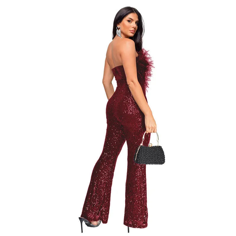 Women's black sleeveless backless jumpsuit with sequin trim and flared legs for evening wear.