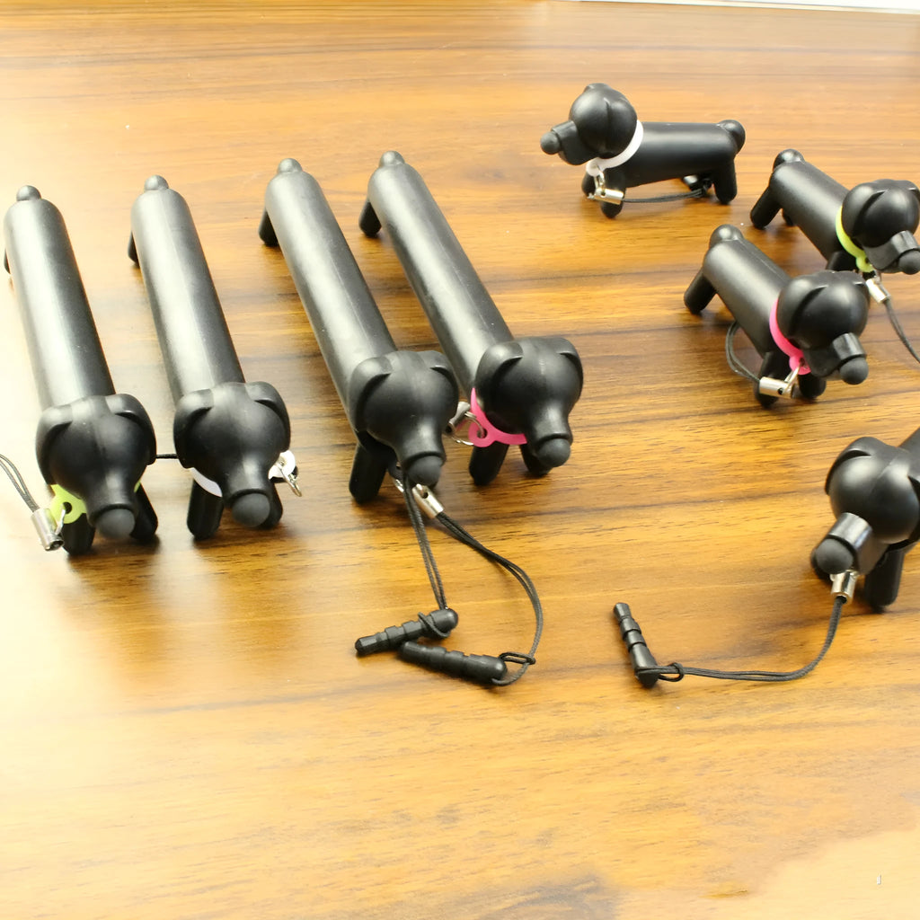 Black dog shaped touch screen stylus showing adjustable length design and phone stand conversion