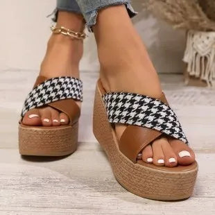 Brown and black plaid pattern casual wedge sandals with a rubber sole.
