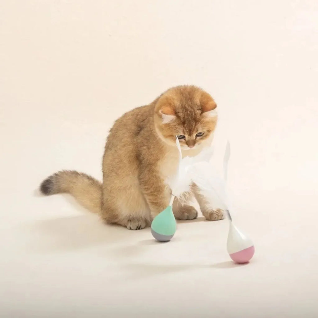 Green or pink feather tumbler cat toy with self-healing base and goose feather teaser.