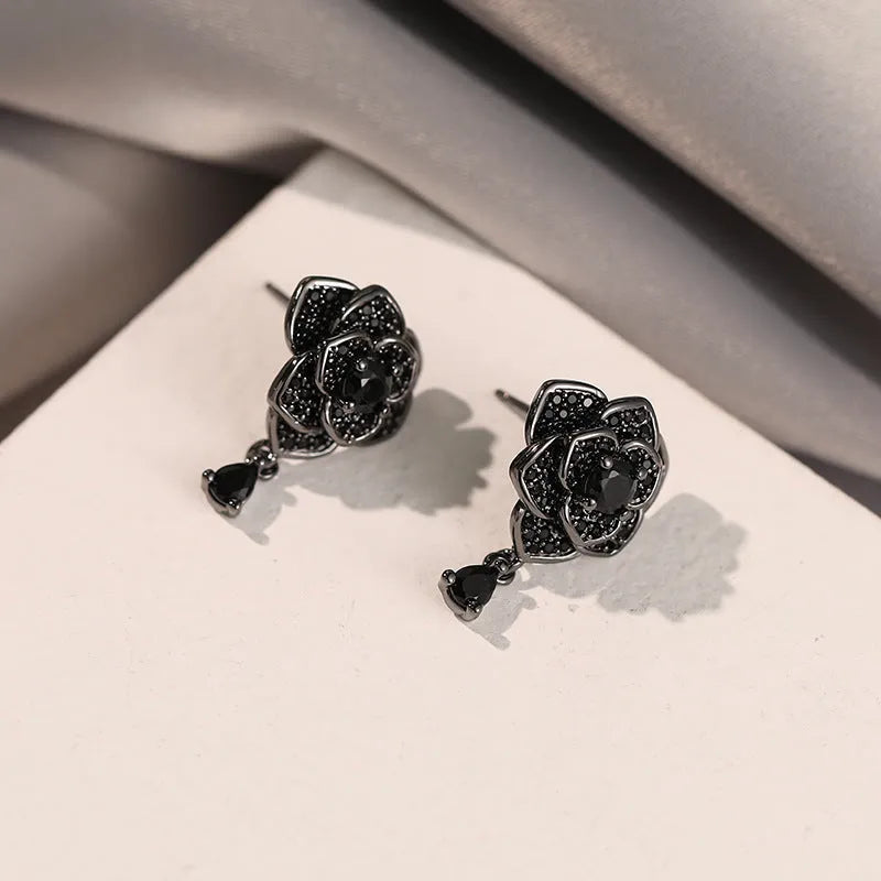Pair of women's black rose zircon floral stud earrings on electroplated 18K copper.