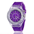 Women's LED luminous watch with round alloy case and colourful silicone strap.