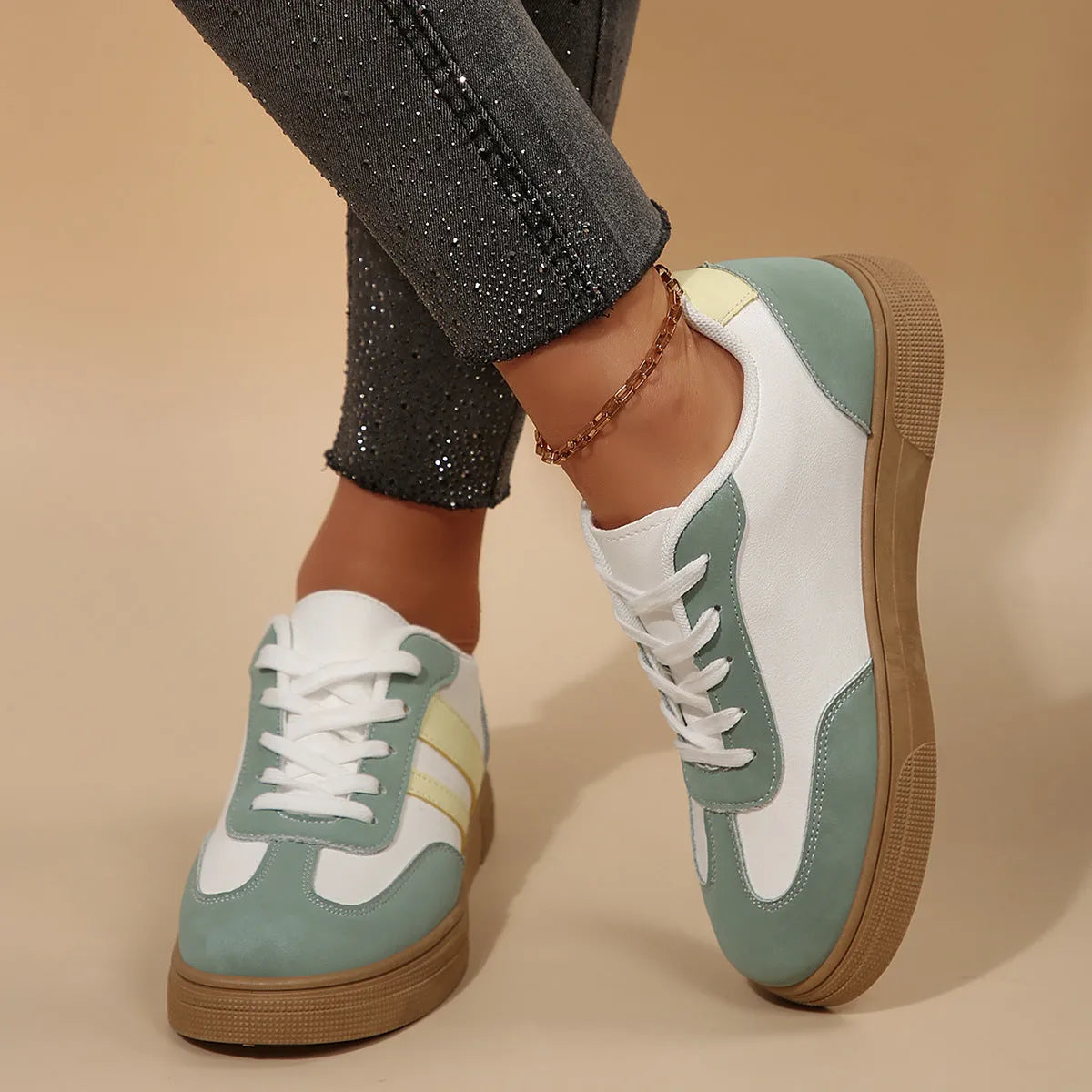 Green women's retro sports pumps with white cross straps and a round toe.