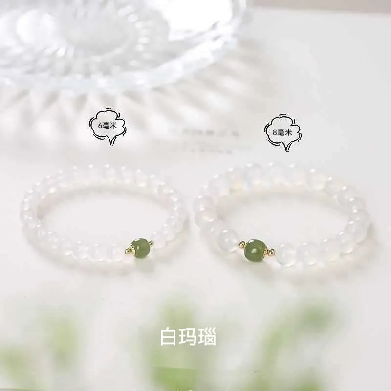 Handmade white agate and Hetian jade bracelet with red cinnabar inlay and a text charm.