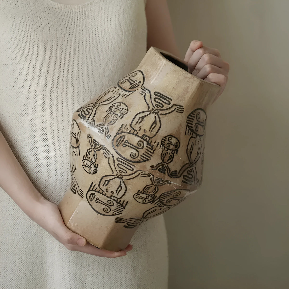 Hand-painted ceramic cylindrical vase with carved religious patterns in tribal totem flower design