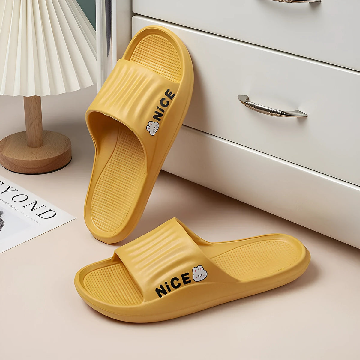 Pair of minimalist cartoon pattern EVA flip flop slippers on a plain background.