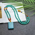 Turquoise stone mesh flower lucky pendant necklace on a ball bead chain, adjustable length.