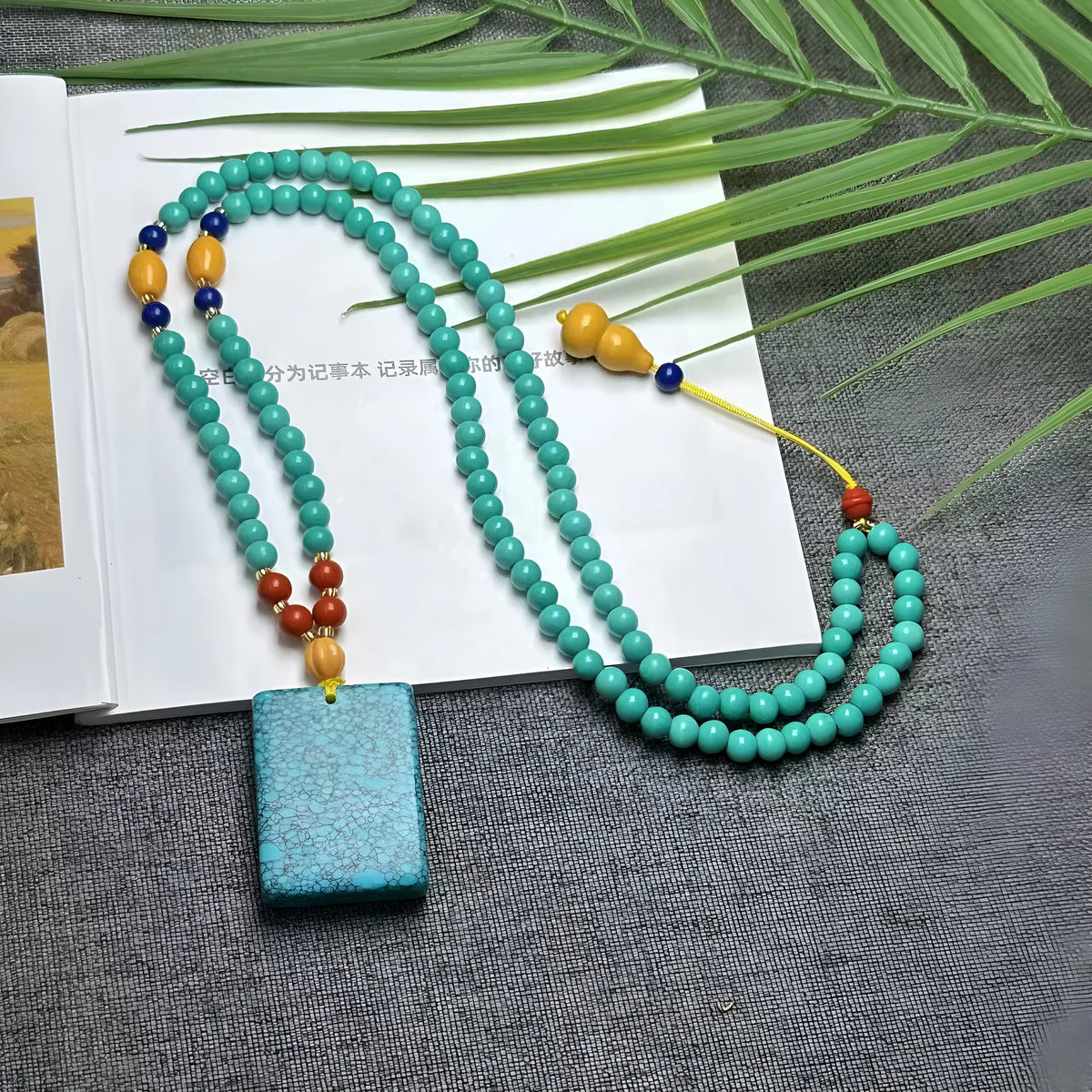 Turquoise stone mesh flower lucky pendant necklace on a ball bead chain, adjustable length.