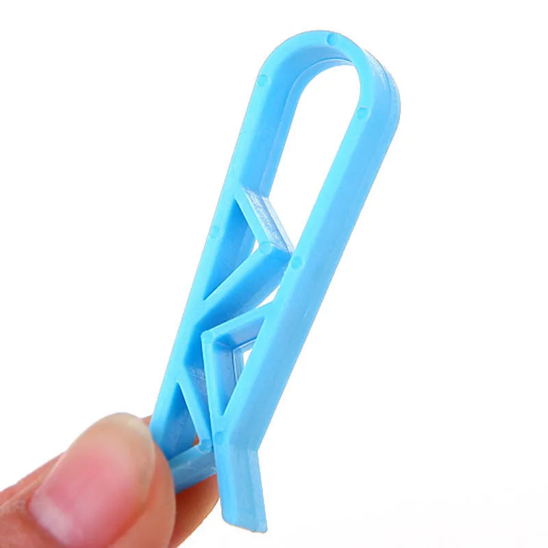 Grey PP plastic non-slip clip for securing bin bags to a rubbish bin rim.