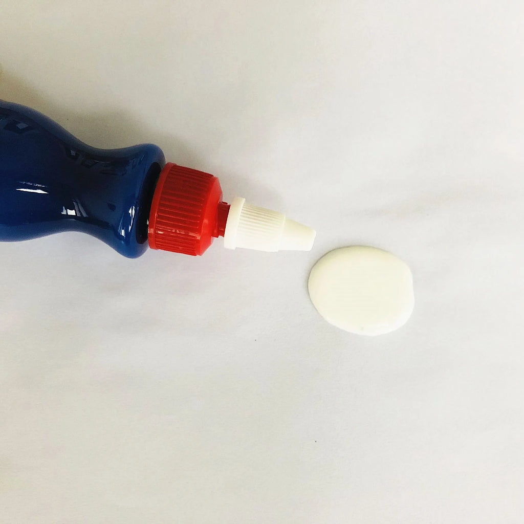 Small blue wiping tool and bottle of automobile scratch repair agent for minor vehicle surface imperfections
