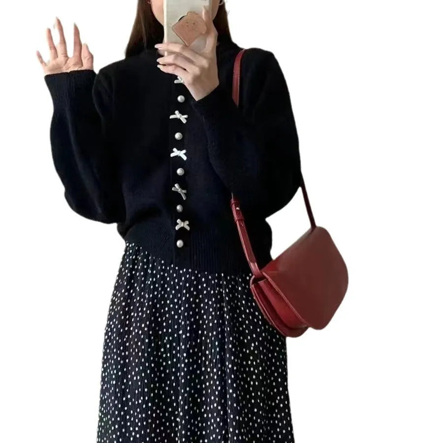 Women's light blue cashmere blend cardigan sweater with pearl buttons and bow detailing on front