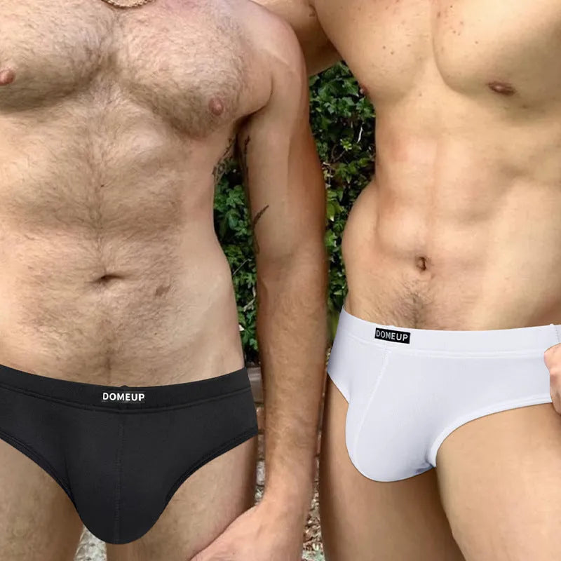 Men's solid colour low-waist seamless briefs in white, black, and pink on a size chart