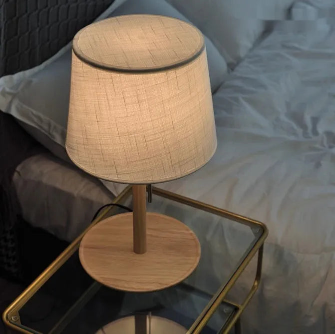 Walnut colour solid wood bedside lamp with white cloth shade and cable switch