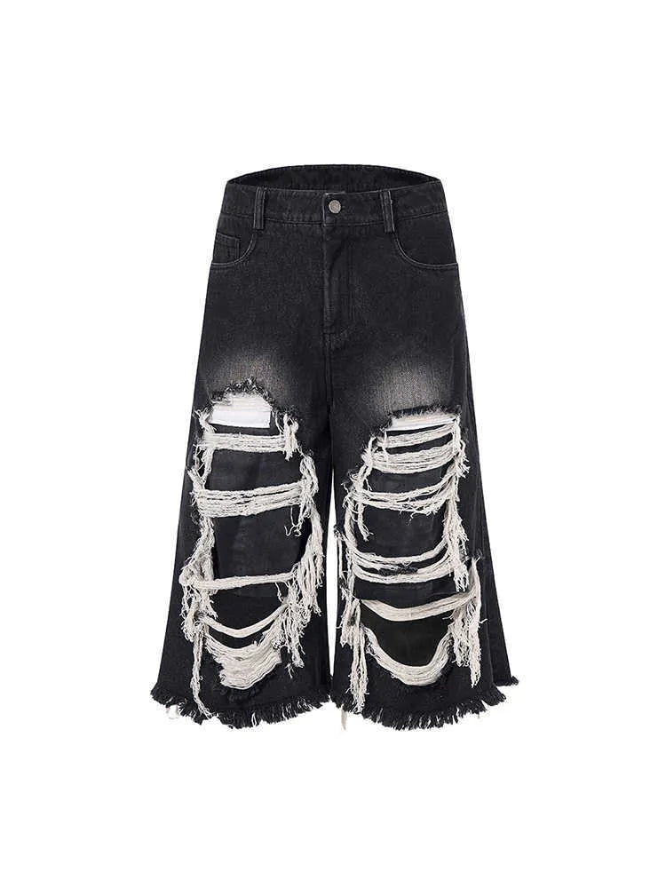 Black cropped wide leg jeans with ripped patch detailing and mid-high waist