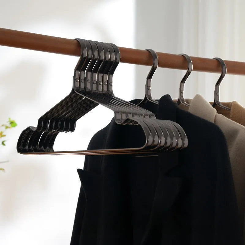 Modern elegant black non-slip clothes hanger on a white background.