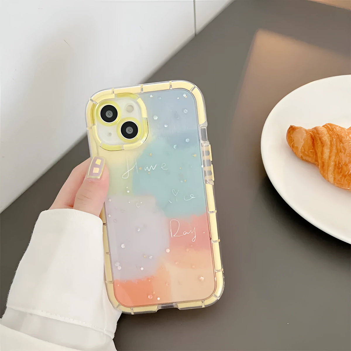 Minimalist silicone phone case for iPhone 14 with a contrasting yellow edge on a white background.