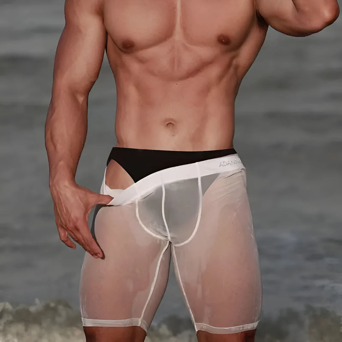 Men's seamless nylon mesh home shorts in black, shown in a casual setting.