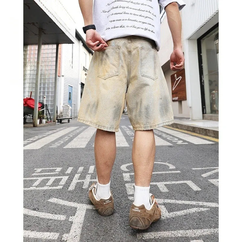 Light blue distressed denim shorts for men with ripped details and straight-leg fit.