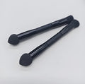 Elegant black double-headed makeup brush with miter sponge and angled concealer heads on a wooden handle.