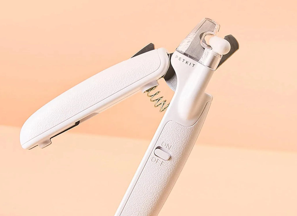 White LED pet nail clippers with transparent anti-splash guard open to show triangular stainless steel blades
